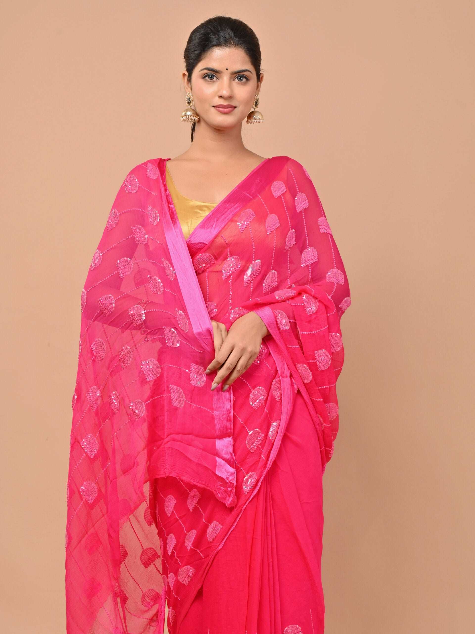 Pure chiffon Rani pink color saree embellished with thread and sequins